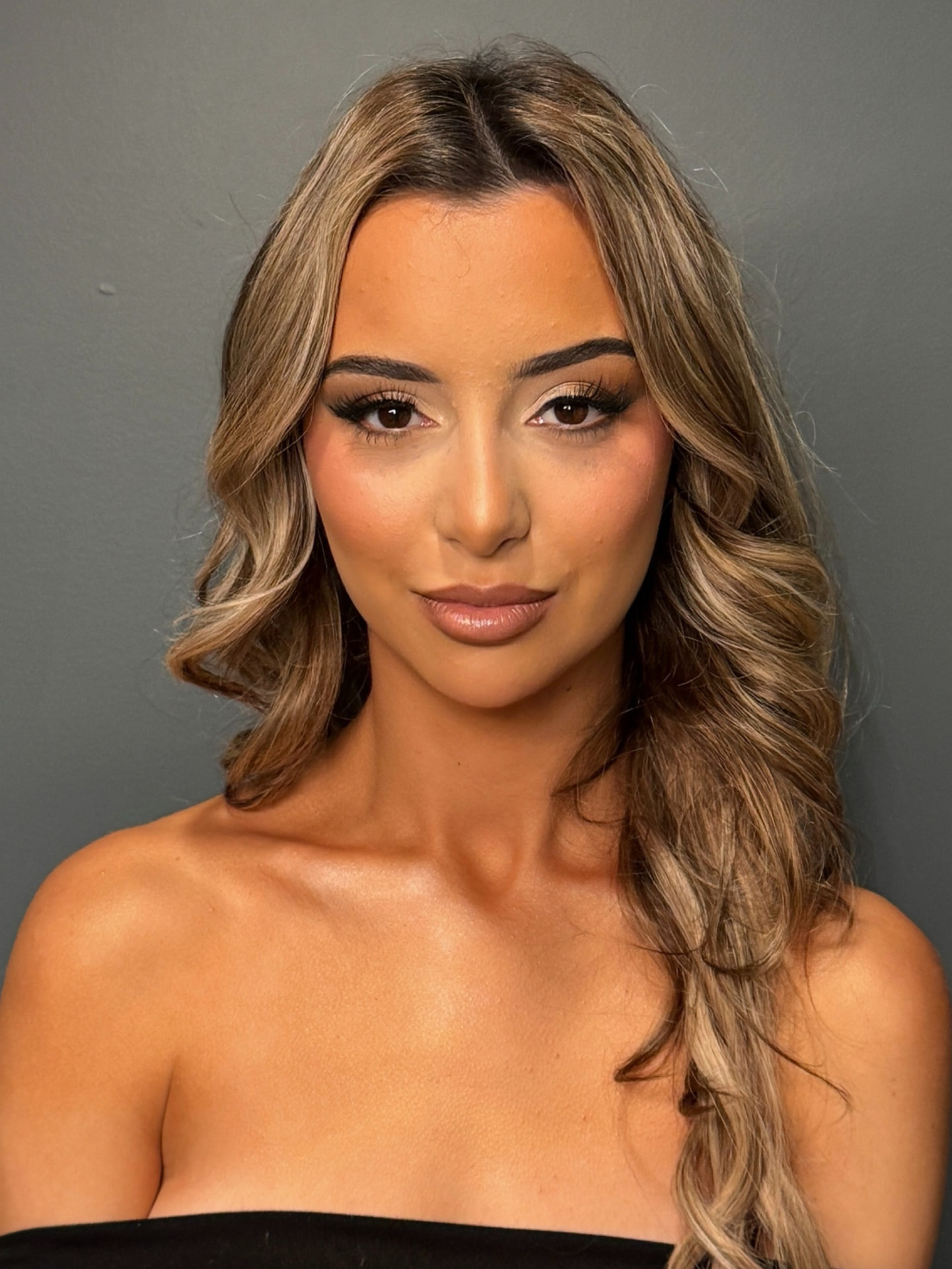 Close bridal makeup look with warm bronzed skin and neutral lip